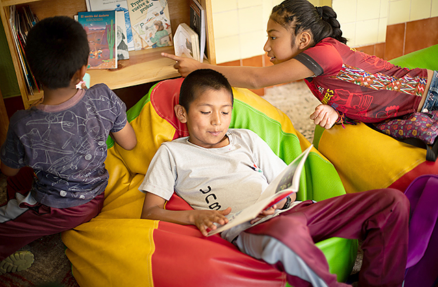 Kids reading at the Child Aid office in Patzún, Guatemala.