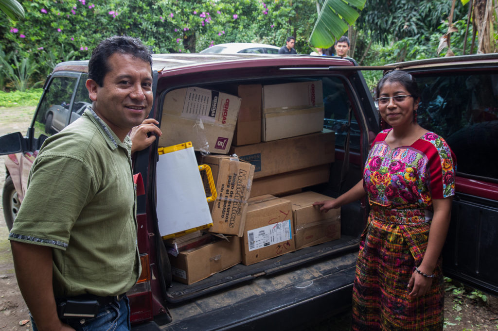 Igor Xoyon shows off his car stuffed with new books destined for his school, Colegio Mi Melodía, in Chimaltenango 