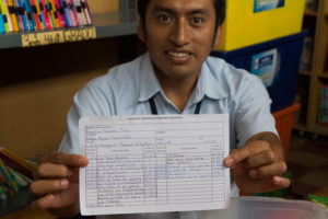 Library Coordinator Carlos Paz holds up an example of the library's new lending cards.